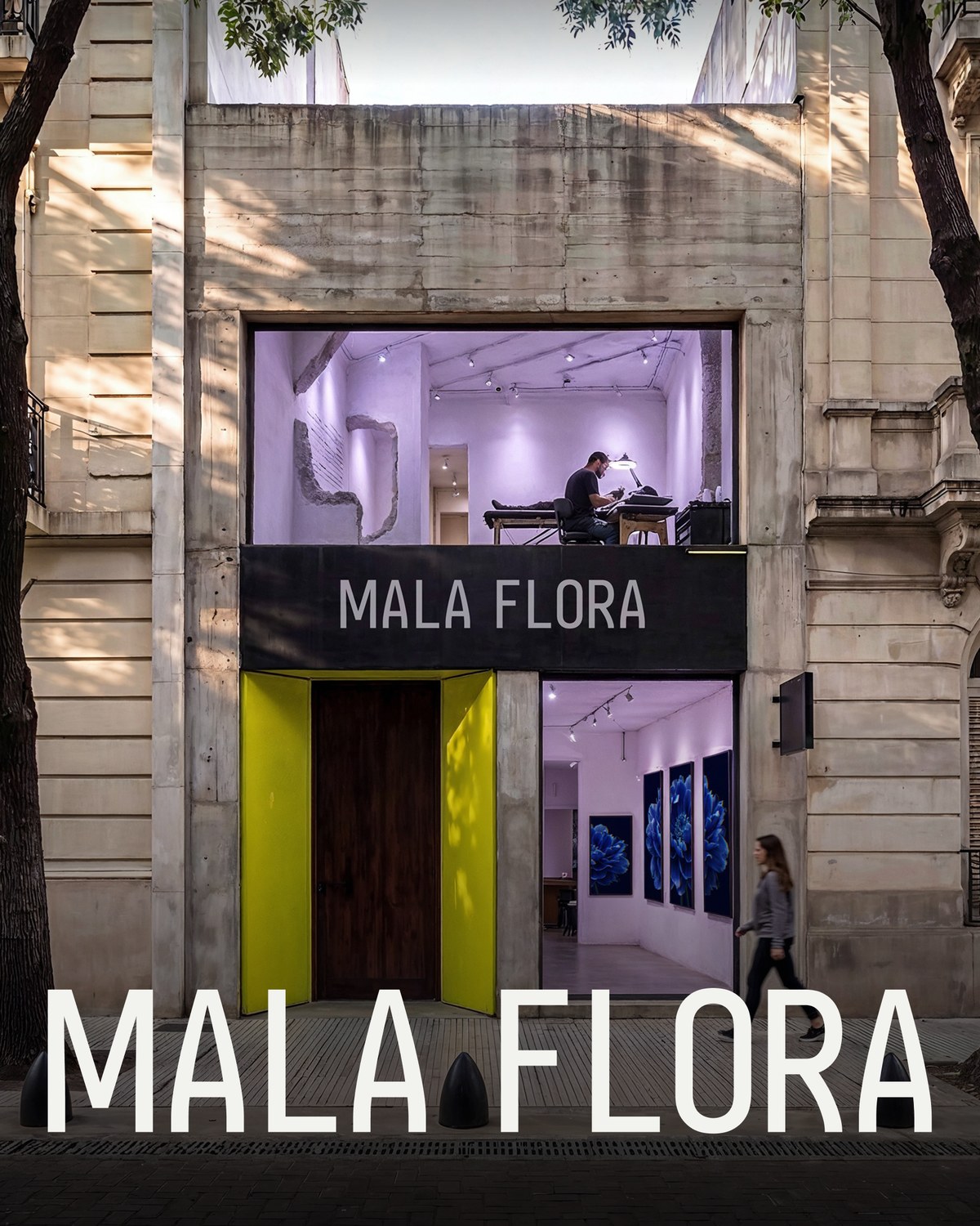 The studio facade in Villa Crespo — the Mala Flora sign over acid-lime doors, the gallery lit behind the glass